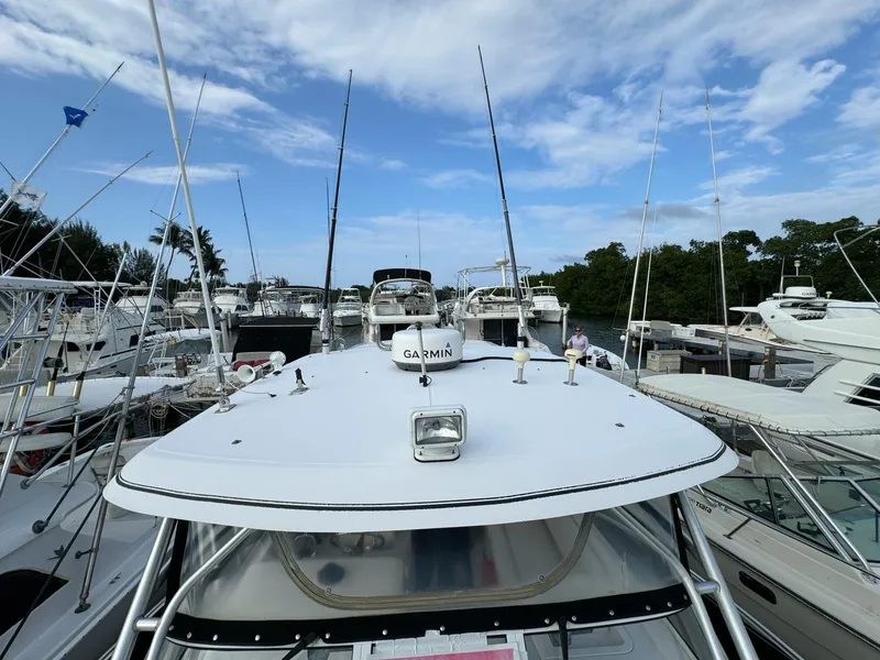 Slide: The Image of 2006 Pro-Line 32 Express boat docked among other vessels under a blue sky. - 12