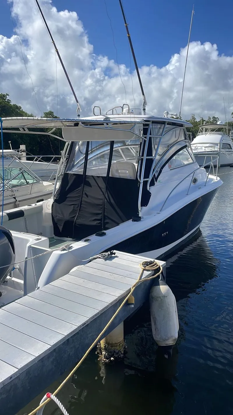 Slide: The Image of 2006 Pro-Line 32 Express boat docked at marina under blue sky. - 3