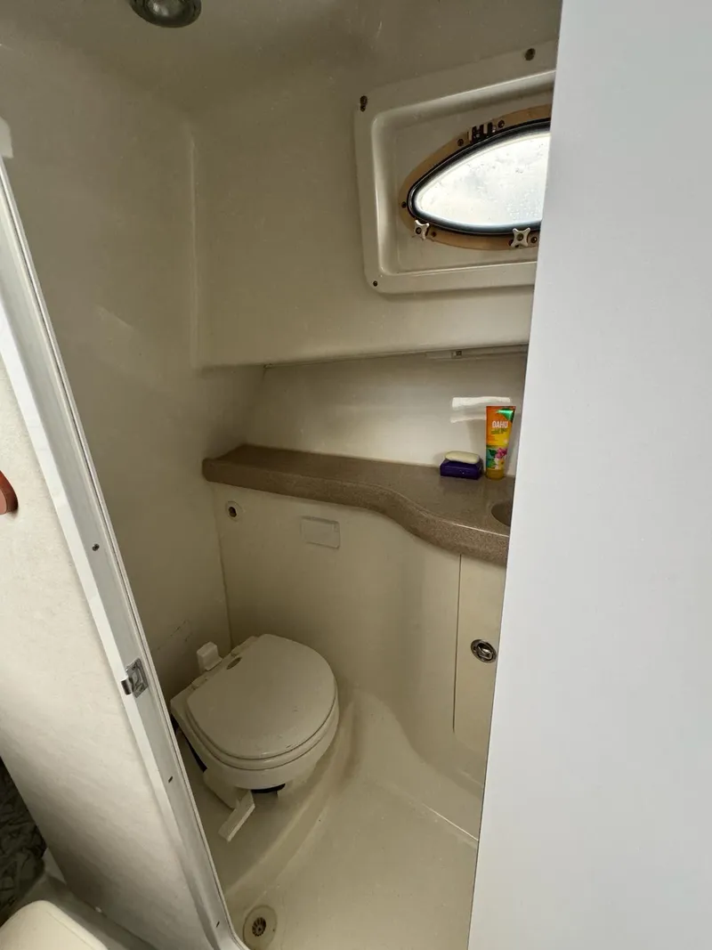 Slide: The Image of 2006 Pro-Line 32 Express boat bathroom with compact toilet and countertop. - 8