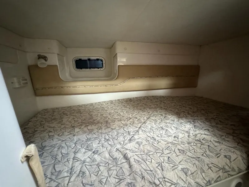 Slide: The Image of 2006 Pro-Line 32 Express cabin interior with patterned bedding and small window. - 9