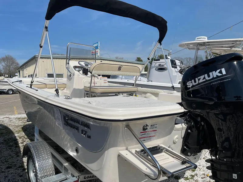 Slide: The Image of 2024 Carolina Skiff 17 LS boat with Suzuki outboard motor on trailer. - 1
