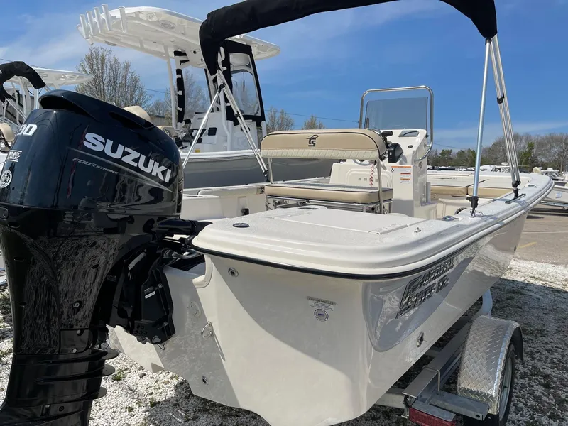 Slide: The Image of 2024 Carolina Skiff 17 LS boat with Suzuki outboard motor on trailer. - 2
