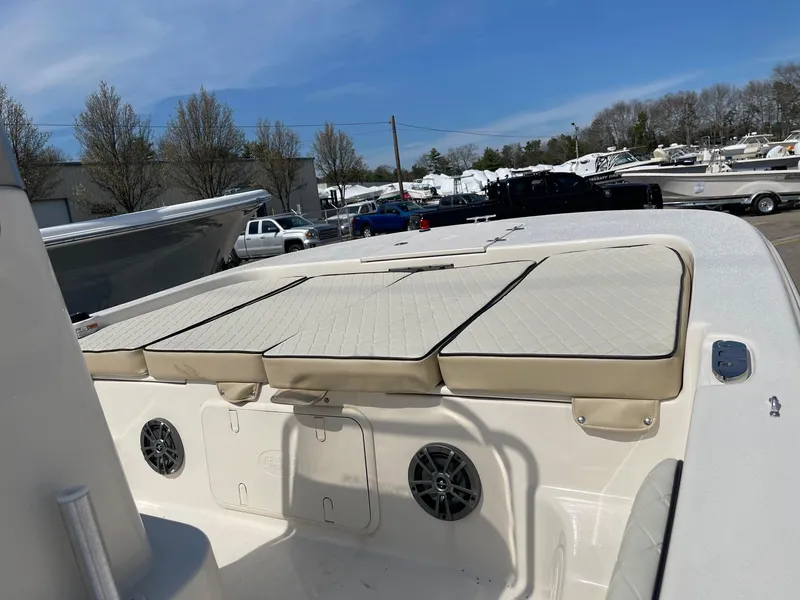 Slide: The Image of 2024 Carolina Skiff 17 LS boat with cushioned seating and storage compartments. - 4