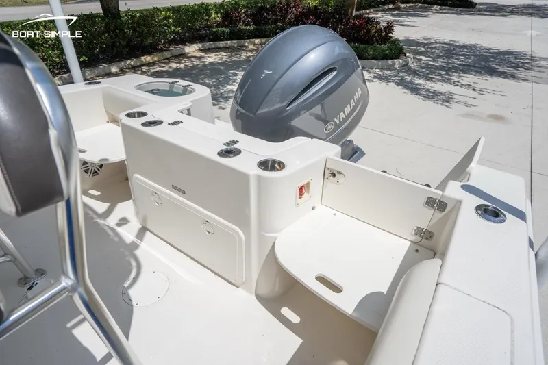 Slide: The Image of 2023 Sailfish 220 CC boat with Yamaha engine, featuring spacious deck and seating area. - 12