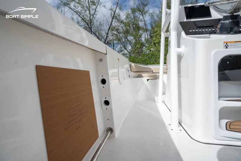 Slide: The Image of 2023 Sea Pro 219 Deep V CC boat interior with console and storage compartments. - 7