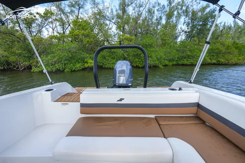 Slide: The Image of 2023 Starcraft SVX 210 OB boat interior with seating and outboard motor. - 9