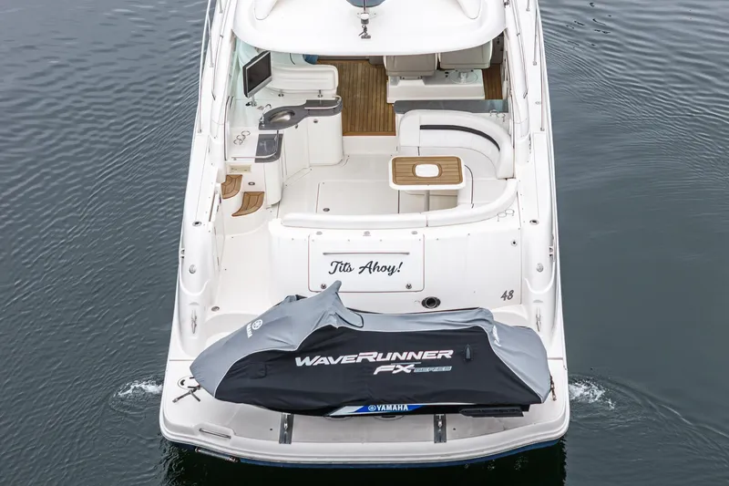 Slide: The Image of 2007 Sea Ray 48 Sundancer yacht with Yamaha WaveRunner on deck, rear view. - 12