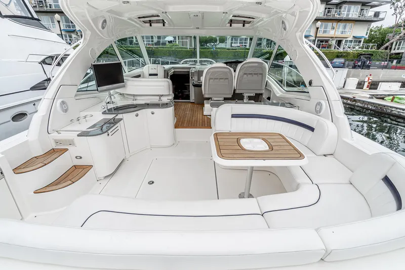 Slide: The Image of 2007 Sea Ray 48 Sundancer yacht interior with white seating and wooden accents. - 13
