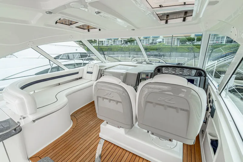 Slide: The Image of 2007 Sea Ray 48 Sundancer yacht interior with white seating and wooden flooring. - 20