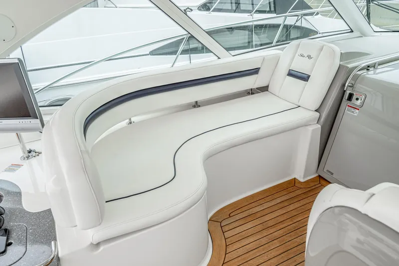 Slide: The Image of 2007 Sea Ray 48 Sundancer interior with white seating and wooden flooring. - 21