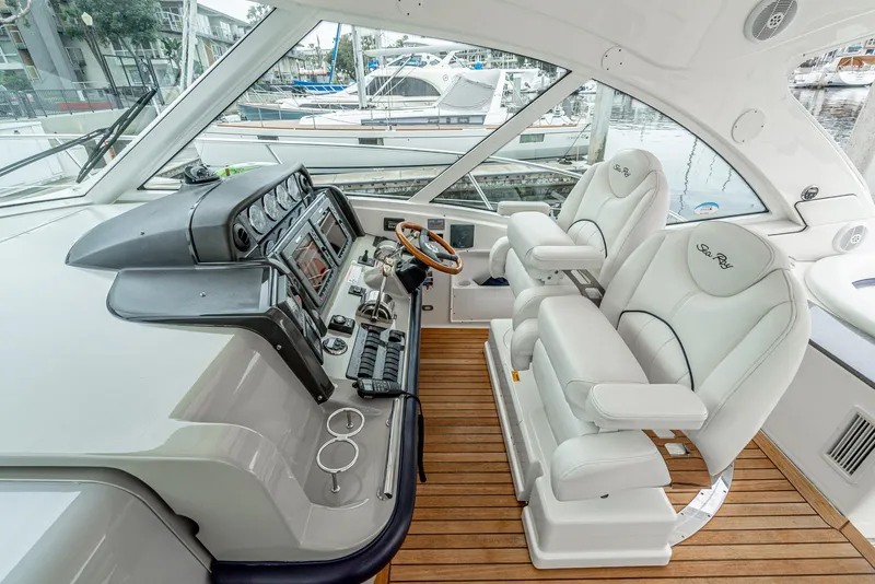 Slide: The Image of 2007 Sea Ray 48 Sundancer helm with dual seats and modern controls. - 23