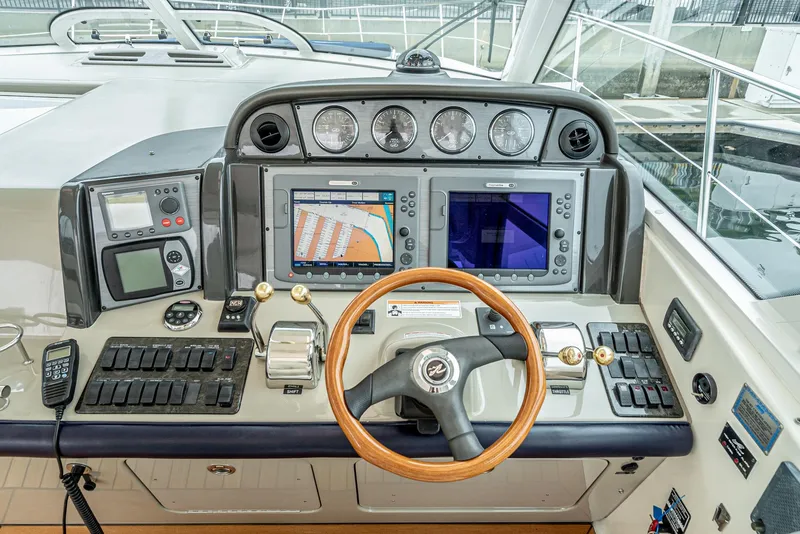Slide: The Image of 2007 Sea Ray 48 Sundancer helm with navigation screens and controls. - 25