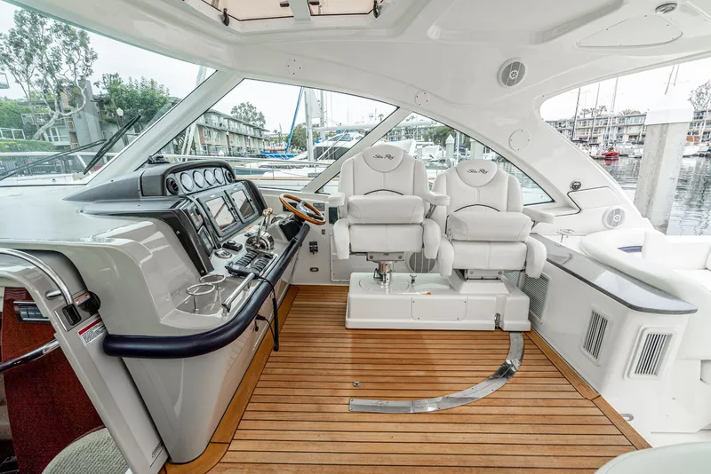 Slide: The Image of 2007 Sea Ray 48 Sundancer cockpit with dual helm seats and modern controls. - 26