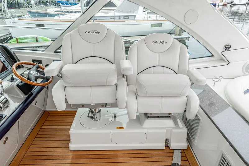 Slide: The Image of Captain's chairs on 2007 Sea Ray 48 Sundancer yacht, featuring luxurious white leather seating. - 27