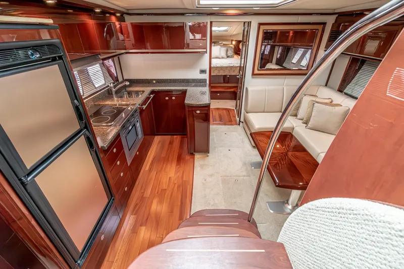 Slide: The Image of Luxurious interior of 2007 Sea Ray 48 Sundancer yacht with kitchen and seating area. - 28