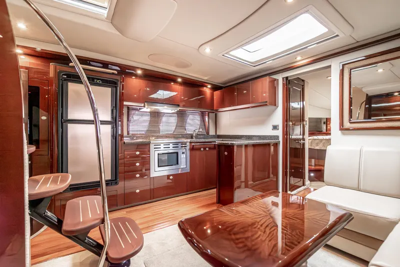 Slide: The Image of Luxurious interior of 2007 Sea Ray 48 Sundancer yacht with modern kitchen and seating area. - 34