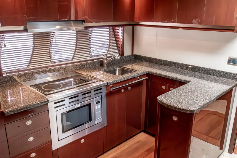 Slide: The Image of Luxurious kitchen in 2007 Sea Ray 48 Sundancer yacht with modern appliances and sleek cabinetry. - 35