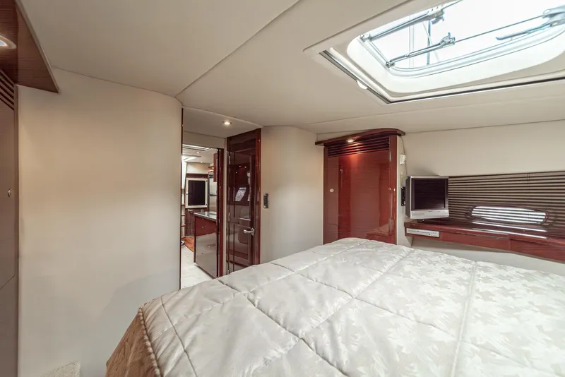 Slide: The Image of Interior of 2007 Sea Ray 48 Sundancer yacht, featuring a luxurious bedroom with skylight. - 37