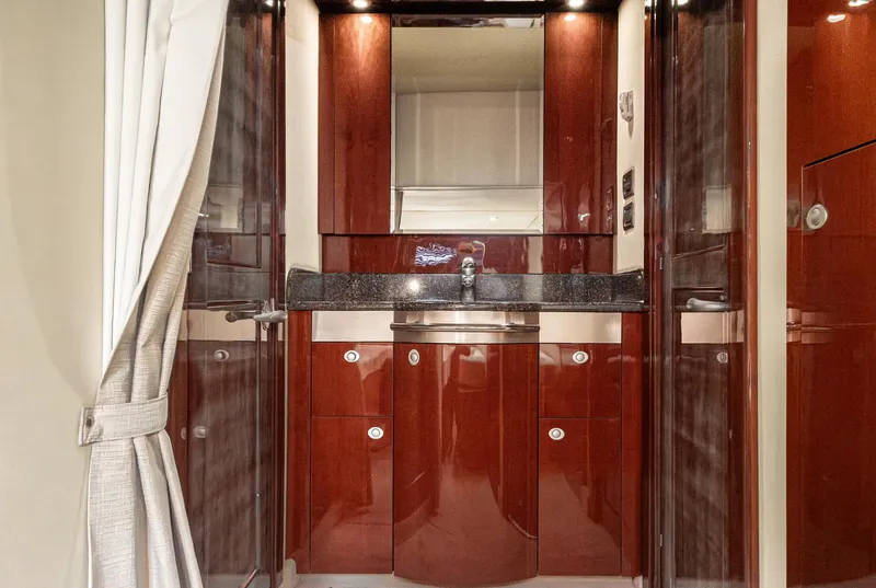 Slide: The Image of Luxurious 2007 Sea Ray 48 Sundancer yacht interior with polished wood cabinetry and modern sink. - 42