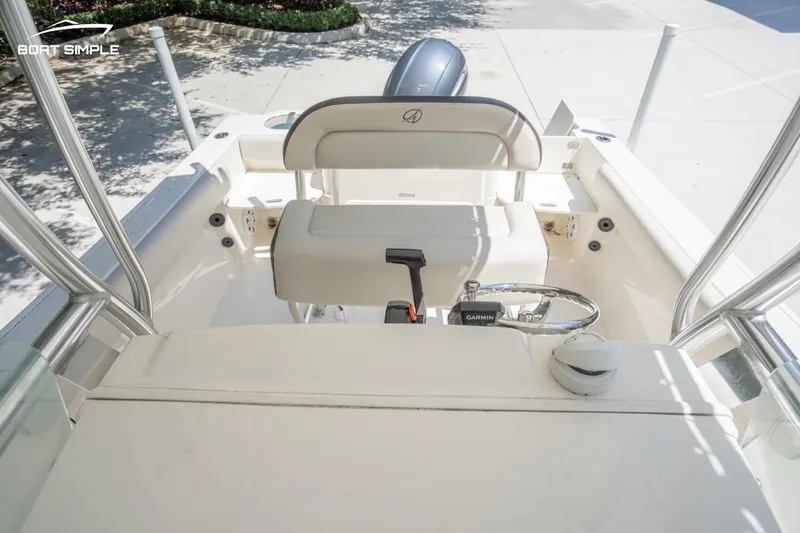 Slide: The Image of 2023 Sailfish 220 CC boat interior with steering console and seating. - 7