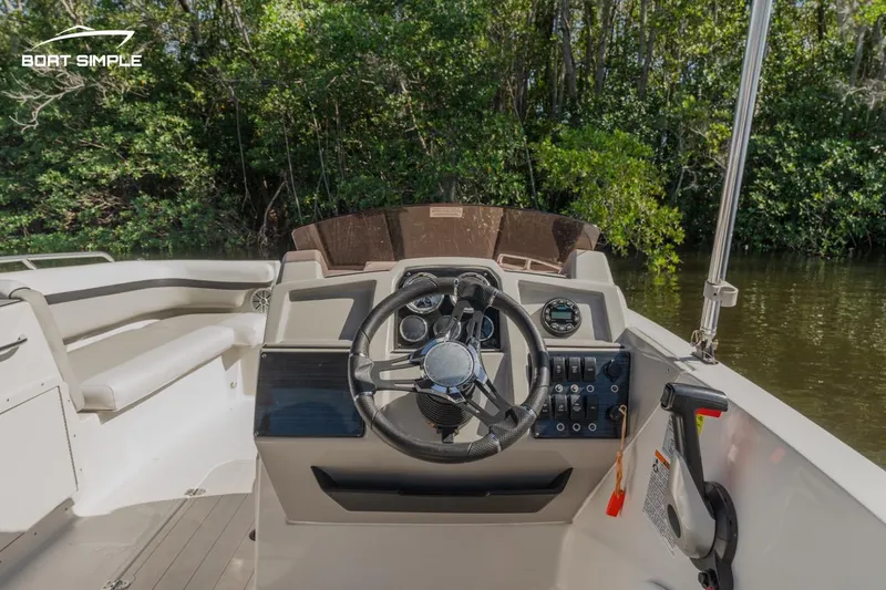 Slide: The Image of 2023 Starcraft SVX 211 OB boat interior with steering wheel and control panel. - 6