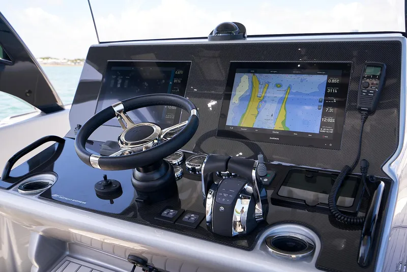 Slide: The Image of 2020 Midnight Express 37' Open boat dashboard with navigation screens and controls. - 12