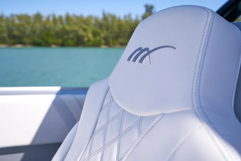Slide: The Image of Close-up of 2020 Midnight Express 37' Open boat's white leather seat with logo. - 7