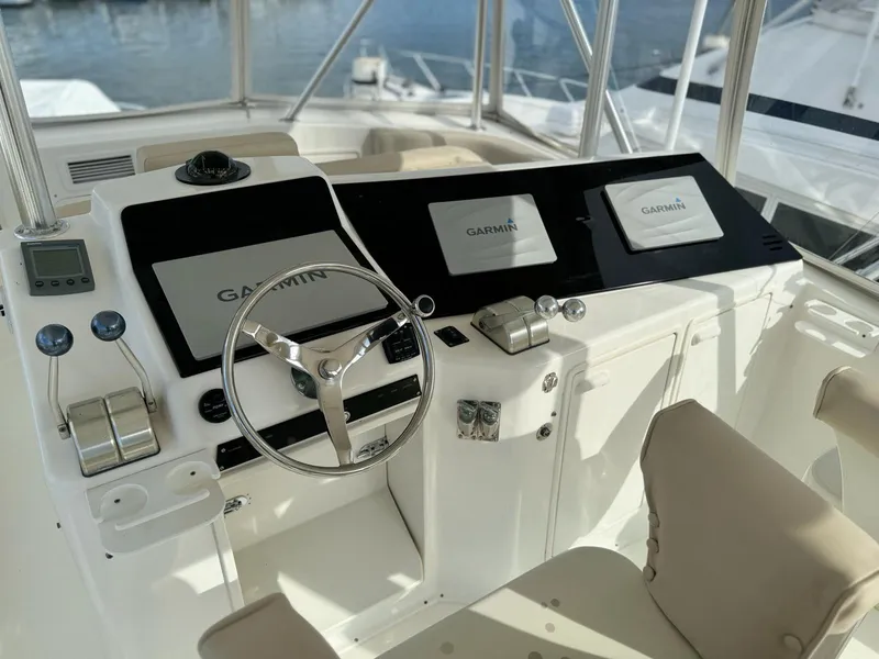 Slide: The Image of Cockpit of 2001 Ocean Yachts 48 with Garmin navigation systems and steering wheel. - 2