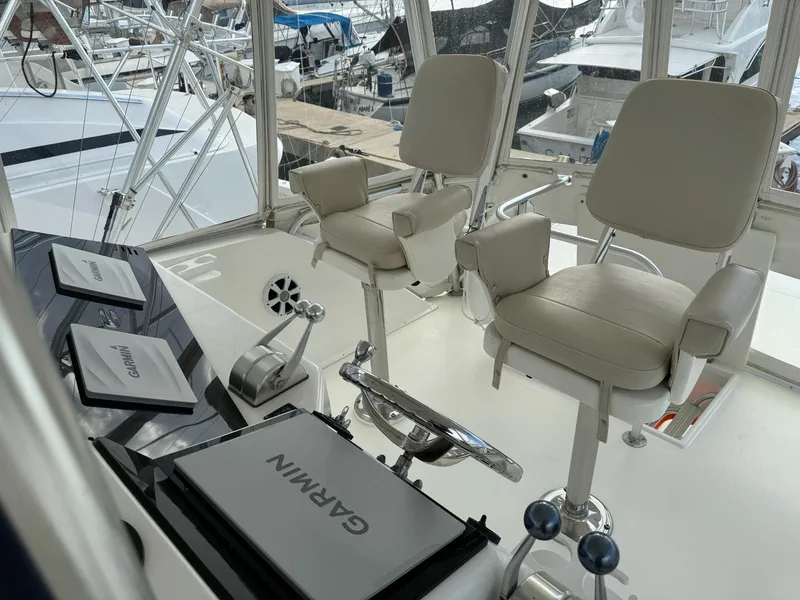 Slide: The Image of Cockpit of 2001 Ocean Yachts 48 with Garmin navigation equipment and two captain chairs. - 3