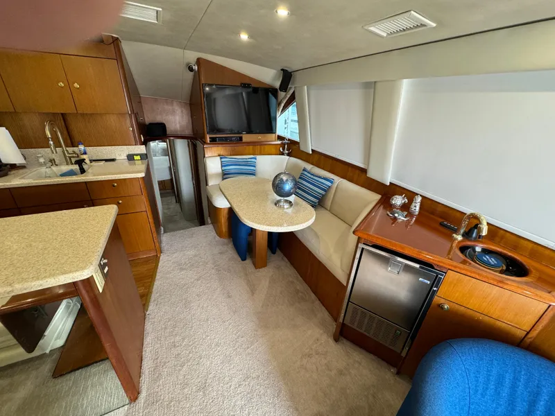 Slide: The Image of Luxurious interior of a 2001 Ocean Yachts 48, featuring a cozy dining area and modern amenities. - 5