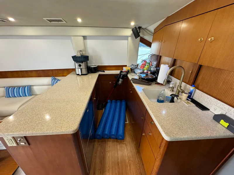 Slide: The Image of Luxurious 2001 Ocean Yachts 48 interior with modern kitchen and seating area. - 6