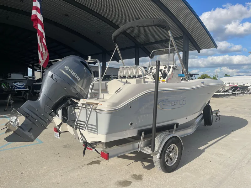 Slide: The Image of 2021 Robalo R180 Center Console boat on trailer with Yamaha outboard motor. - 1