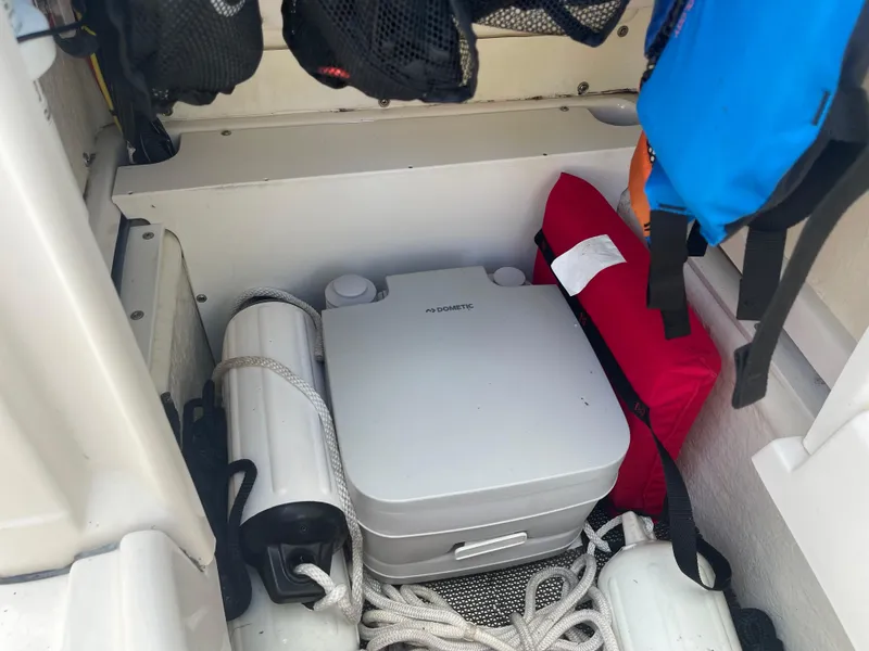 Slide: The Image of Storage compartment of a 2021 Robalo R180 Center Console boat with safety gear. - 14