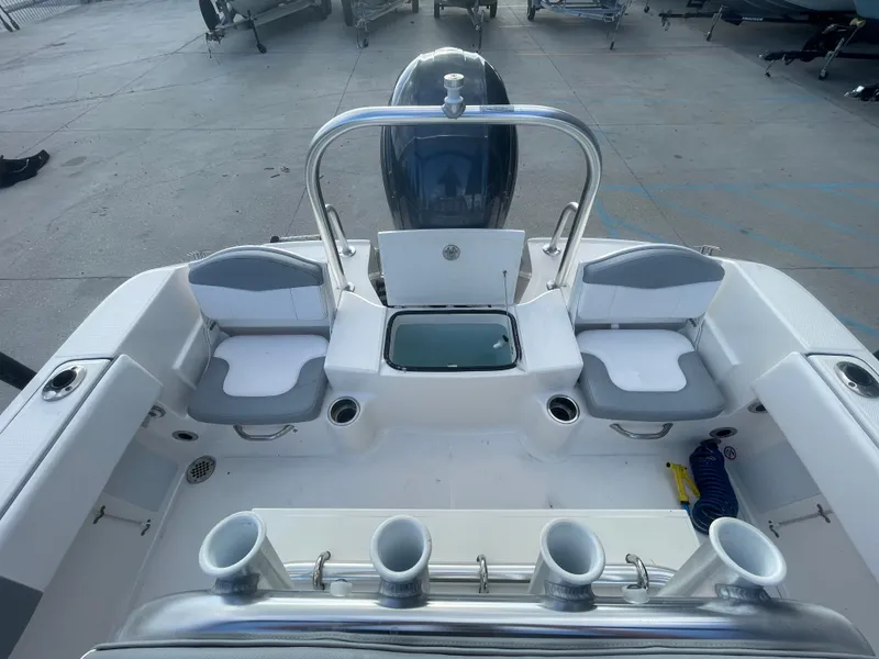 Slide: The Image of 2021 Robalo R180 Center Console boat interior with seating and rod holders. - 17