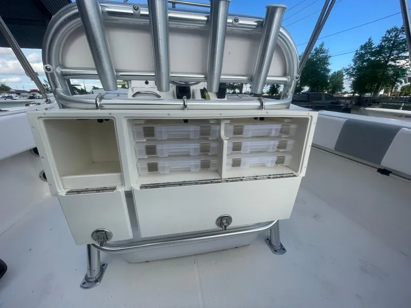 Slide: The Image of 2021 Robalo R180 Center Console storage compartments and rod holders. - 19