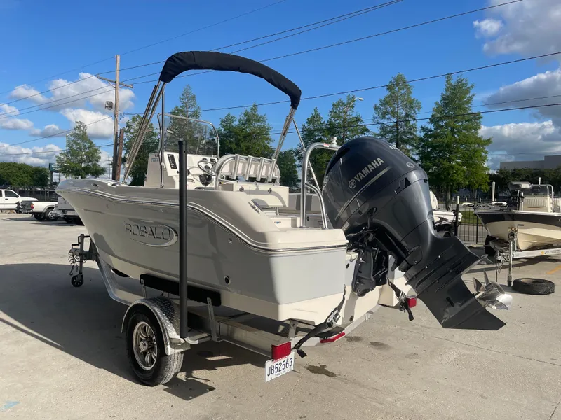 Slide: The Image of 2021 Robalo R180 Center Console boat with Yamaha outboard motor on trailer. - 2