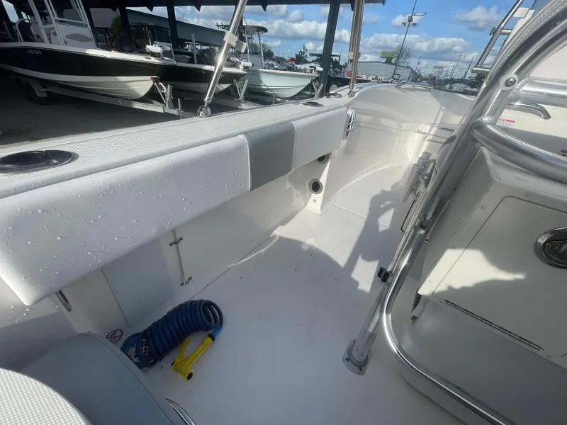 Slide: The Image of 2021 Robalo R180 Center Console boat interior with seating and storage compartments. - 21