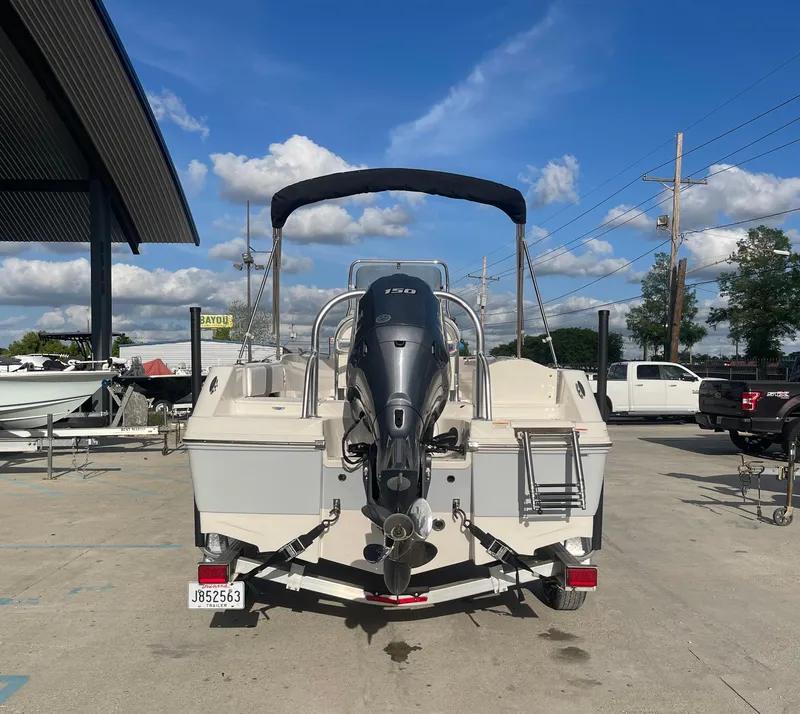 Slide: The Image of 2021 Robalo R180 Center Console boat with outboard motor, parked on a trailer. - 3