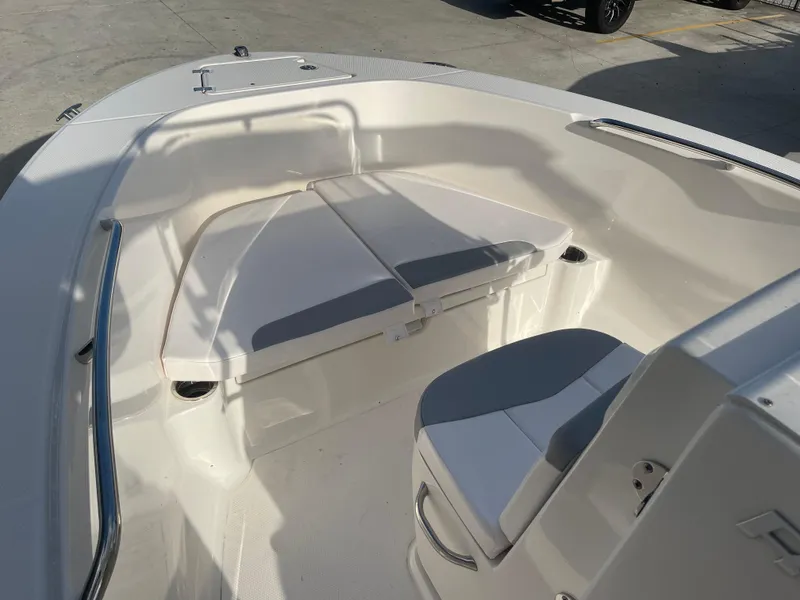 Slide: The Image of 2021 Robalo R180 Center Console boat interior with cushioned seating. - 8