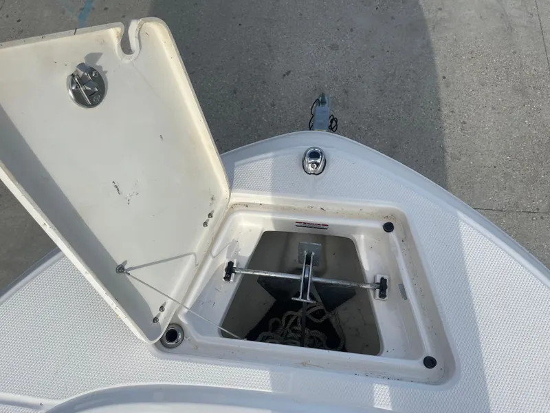 Slide: The Image of 2021 Robalo R180 Center Console anchor storage compartment with open lid. - 9