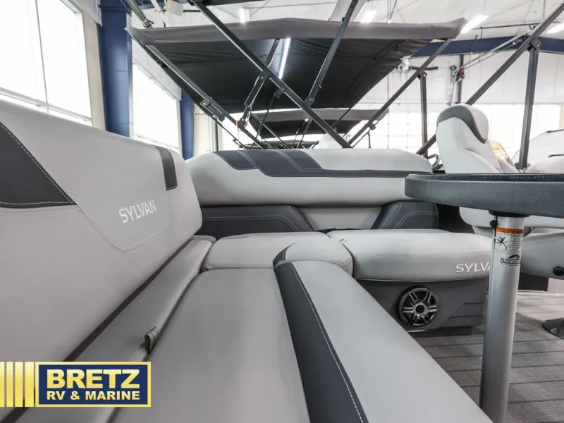Slide: The Image of 2024 L3 CLZ DH boat interior with gray seating and table, Bretz RV & Marine logo. - 7