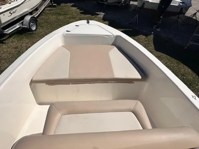Slide: The Image of 2022 Scout 175 Sportfish boat interior with beige seating and spacious deck. - 2