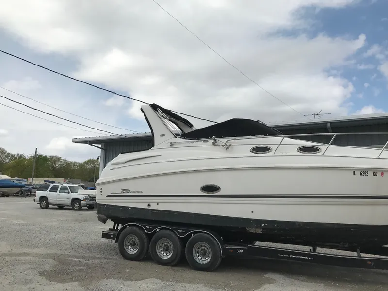 Slide: The Image of 2002 Chaparral Signature 300 boat on a trailer in a parking lot. - 10