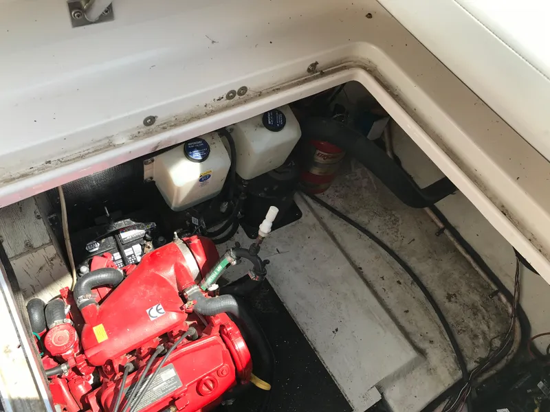 Slide: The Image of 2002 Chaparral Signature 300 engine compartment with red engine and fire extinguisher. - 18