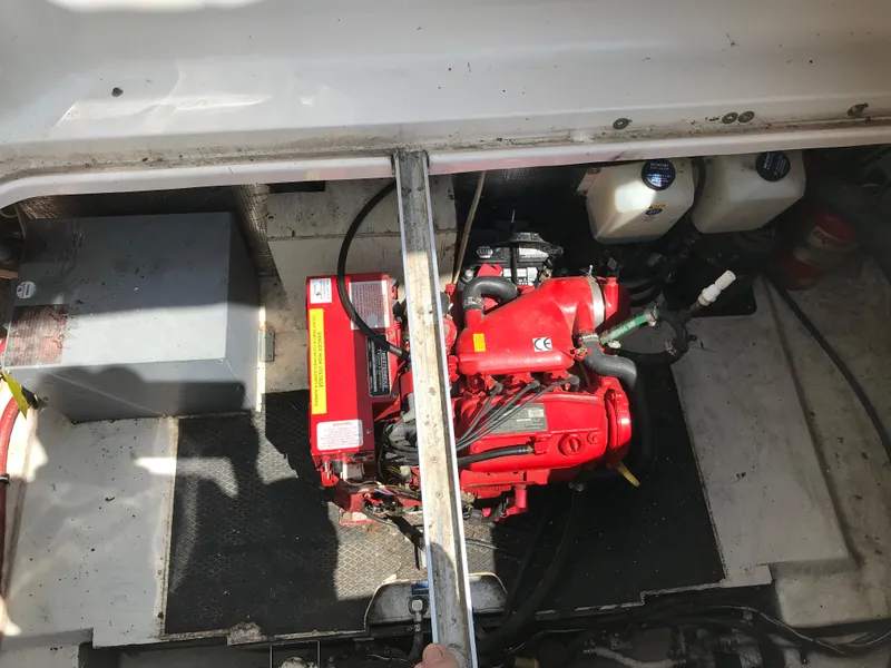 Slide: The Image of 2002 Chaparral Signature 300 engine compartment with red engine and components. - 19