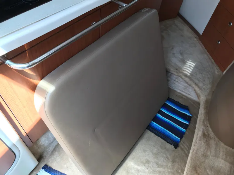 Slide: The Image of 2002 Chaparral Signature 300 interior with cushion and striped rug. - 24