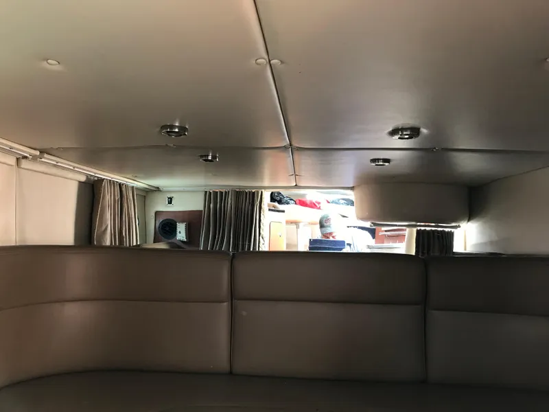 Slide: The Image of Interior cabin of 2002 Chaparral Signature 300 boat with seating and curtains. - 25