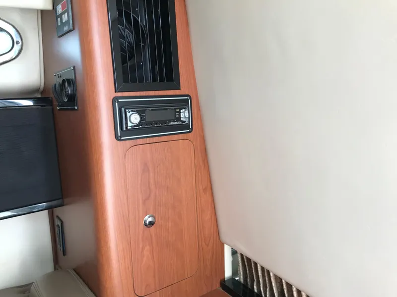 Slide: The Image of Interior cabin of 2002 Chaparral Signature 300 boat with wood paneling and stereo system. - 29