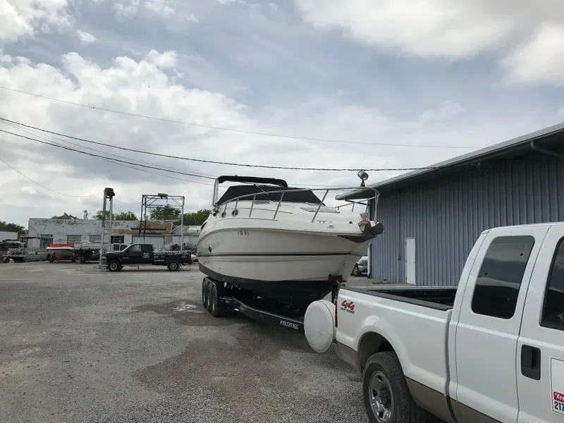 Slide: The Image of 2002 Chaparral Signature 300 boat on trailer, parked beside a white truck. - 3