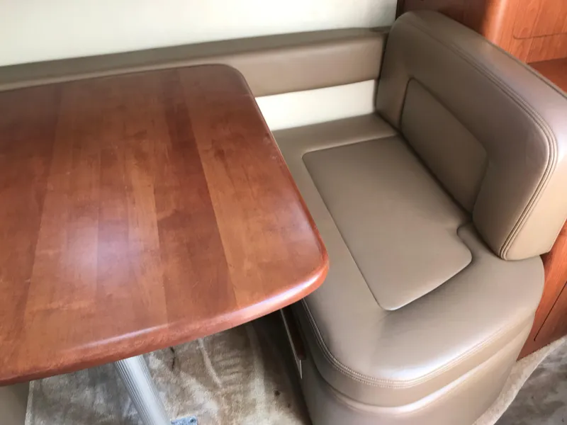 Slide: The Image of 2002 Chaparral Signature 300 interior dining area with wooden table and leather seating. - 35